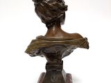statue of a woman ' s head on a marble bust