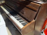 a piano that is sitting on a shelf in a room