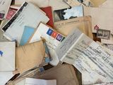 a pile of old letters and envelopes on the ground