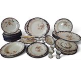 a lot of plates and bowls that are sitting on a table