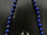 a necklace and earring set made of lapis beads