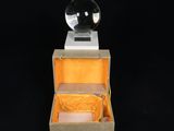 an open box with a crystal ball inside on a black background