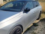 the car is parked on the side of the road in the dirt