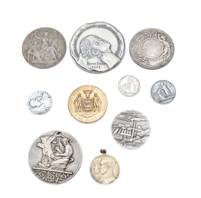 a lot of coins that are on a white surface