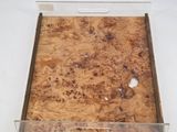 a box that has a piece of wood in it