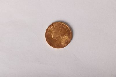 a close up of a penny on a white surface with a white background