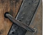 a piece of wood that has a piece of metal on it