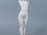 a white statue of a woman with her hands on her head