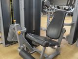 a gym room with a row of machines and other equipment