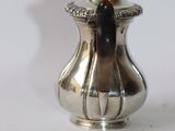 a silver vase that is sitting on a table