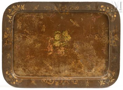 an old metal tray with a floral design on it