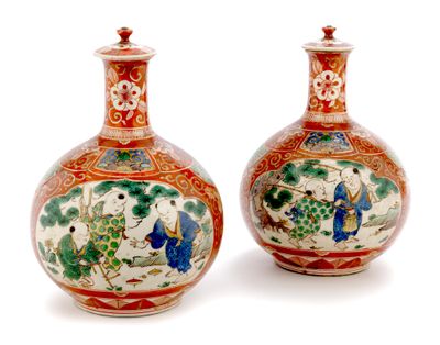pair of chinese vases with colorful designs on them on a white surface