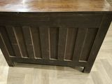 a small wooden chest on a hard wood floor