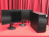 two computer monitors on a red table with red curtains