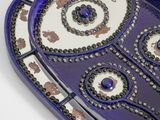 a blue and white tray with a design on it