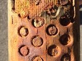 someone is holding an old cell phone that has holes in it