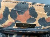 a close up of a handbag with a leopard print pattern on it