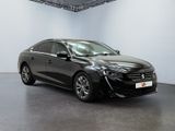 the black car is parked in a large room with white walls