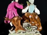 a figurine of two people sitting on a tree stump