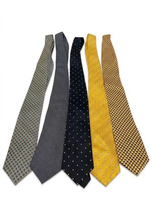 four different colored ties are lined up on a white surface