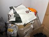 a pile of boxes and bags in the corner of a room