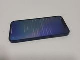 the back of a black samsung s9 with a blue screen on a white table