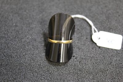 a small black object with a gold band on it