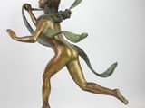 bronze statue of a woman holding a ribbon in her hands
