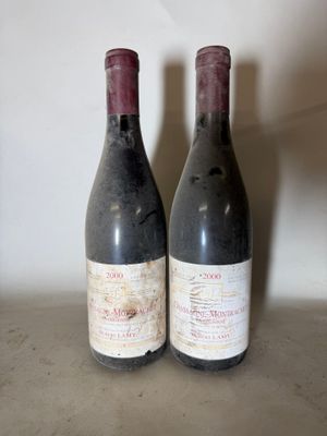 two bottles of wine sitting on top of a table next to each other