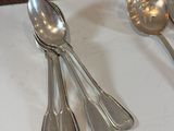three spoons and two spoons on the table