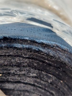 a close up of a piece of cloth in a bowl of water