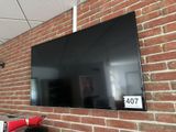 a large flat screen tv mounted on a brick wall