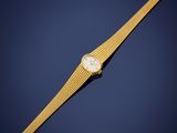a gold wrist watch with a white dial on a blue background