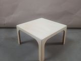 an image of a white coffee table on a concrete floor