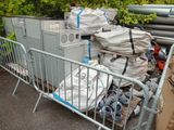 a large pile of garbage sitting behind a metal barricade