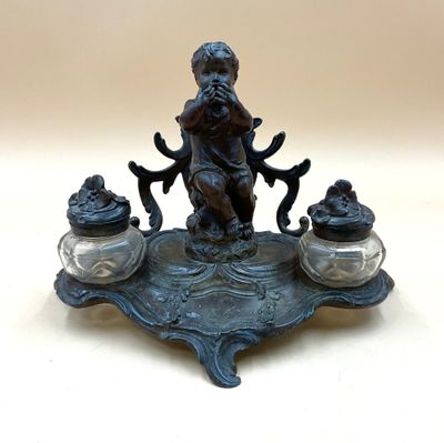 a statue of a boy sitting on top of a table
