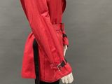 a mannequin wearing a red jacket and black pants