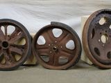 three old wheels are sitting next to each other on a table