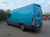 a blue van that is parked in a parking lot
