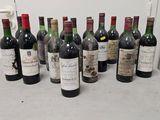 several bottles of wine are lined up on a counter