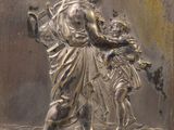 a metal plaque with a picture of a man holding a child
