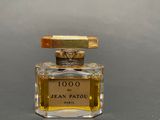 an image of a bottle of perfume sitting on top of a table