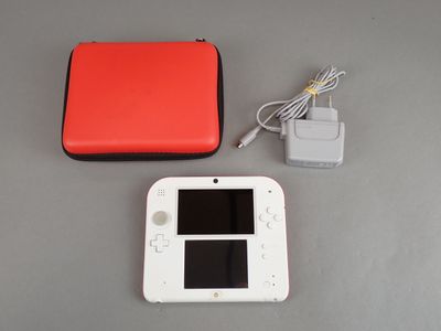a nintendo wii game console with a red case and a charger