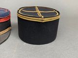 two hats that are sitting next to each other on a table