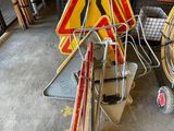a pile of construction signs on the floor in a garage