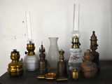 many different types of antique lamps on a table