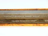 a close up of a metal knife on a wooden table