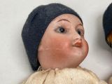 two dolls that are sitting next to each other