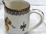 a white pitcher with a horse and a man on it