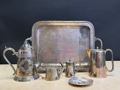 a silver tray with a silver tea set and a silver tray with a silver teapot